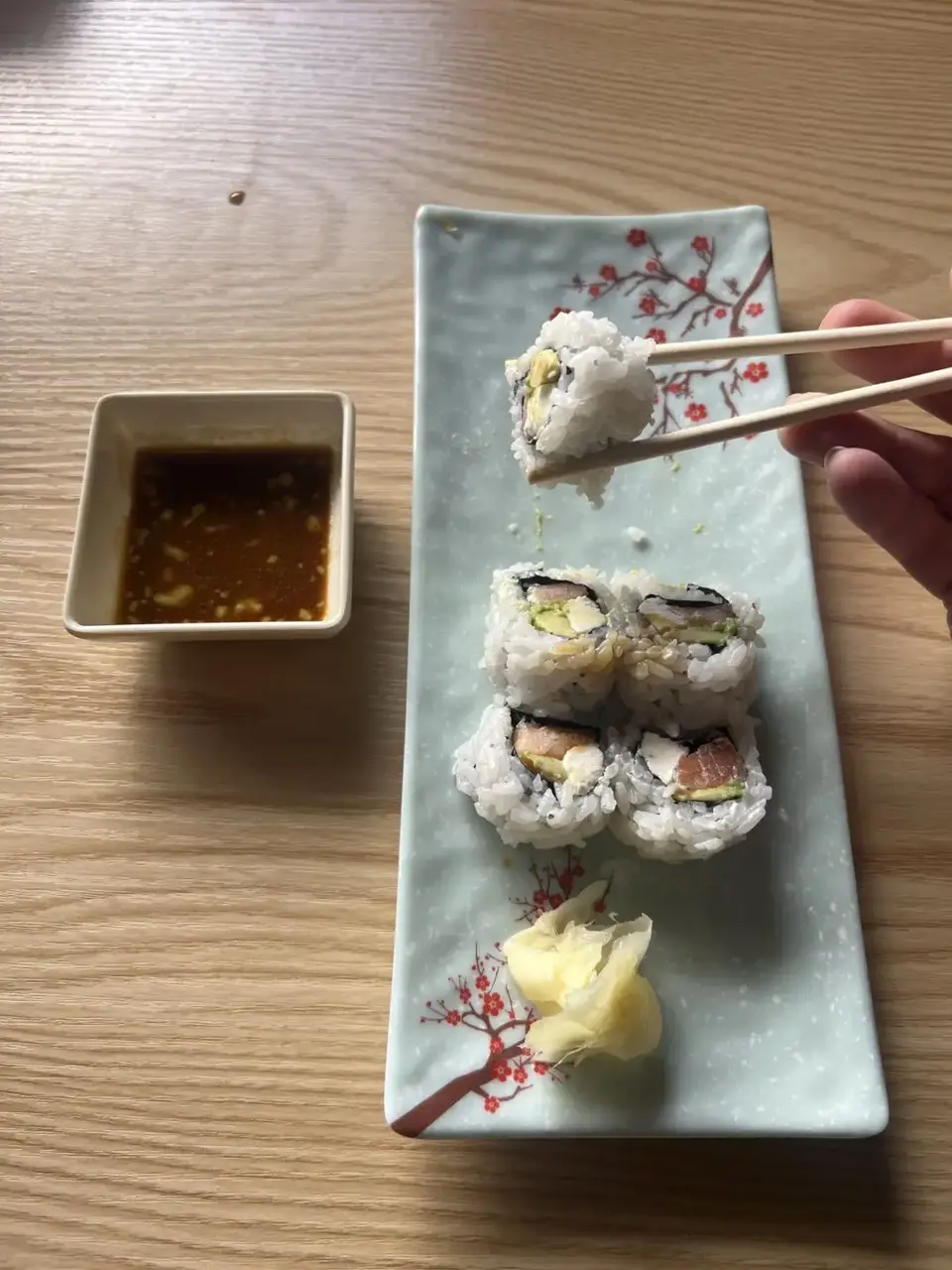 Freshly prepared sushi rolls on a decorative platter with ginger and soy sauce at Ichigo.
