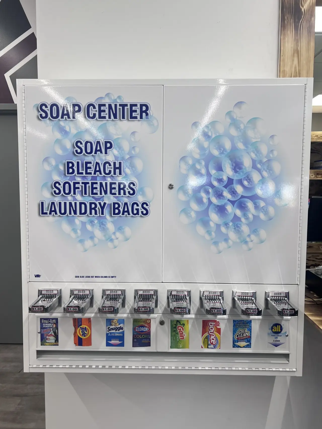 Soap Center offering packets of soap, bleach, softeners, and laundry bags inside Uptown Laundry