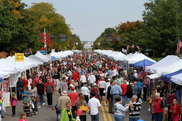 A dense Market Day crowd between the tent rows