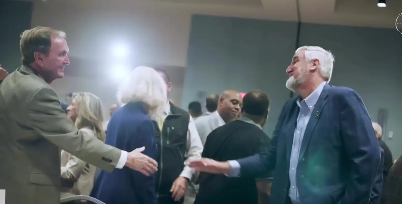 OneZone members greeting each other at a chamber event