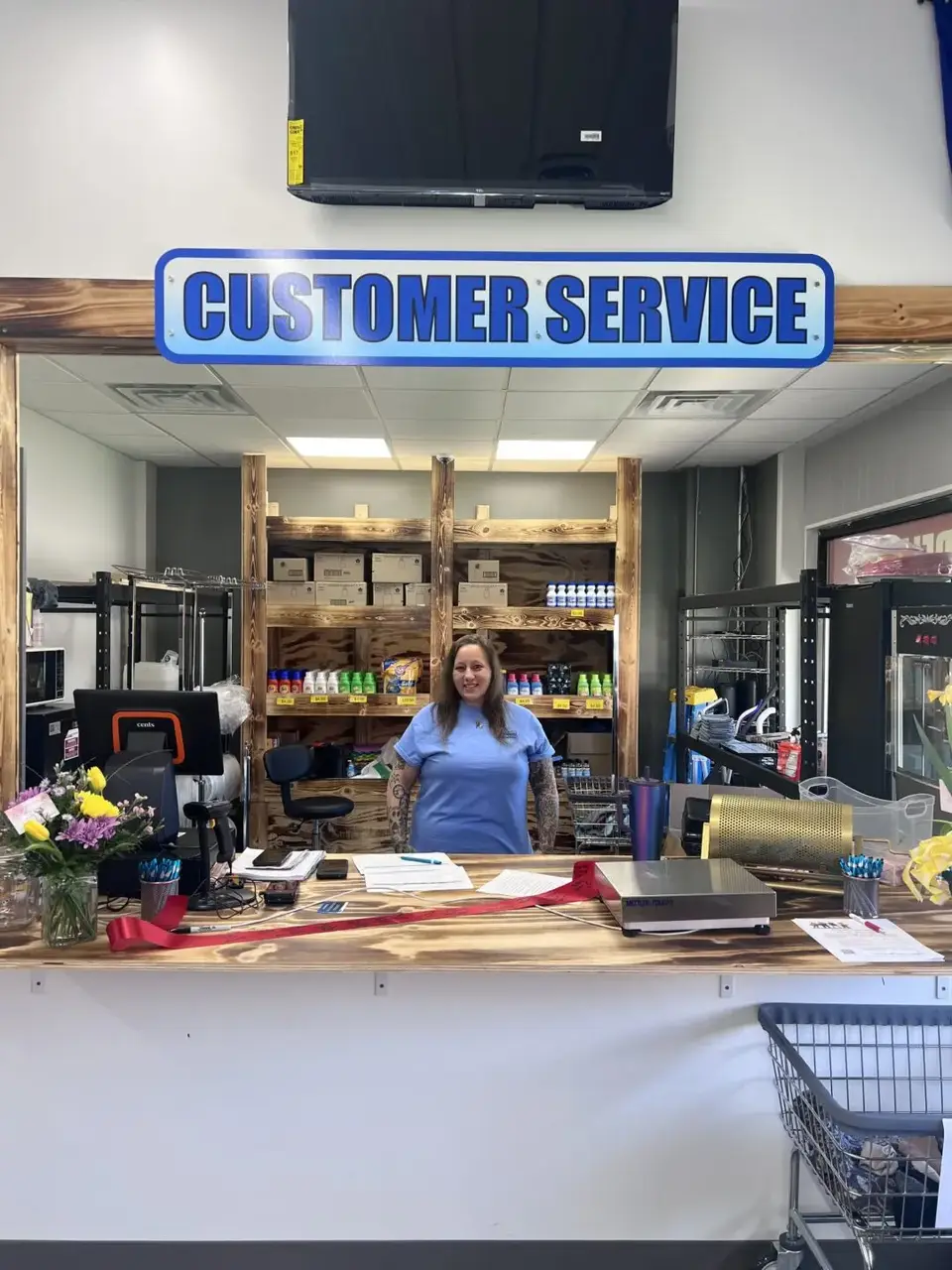 Customer service counter inside Uptown Laundry with on-site staff assistance and supplies visible behind the desk.