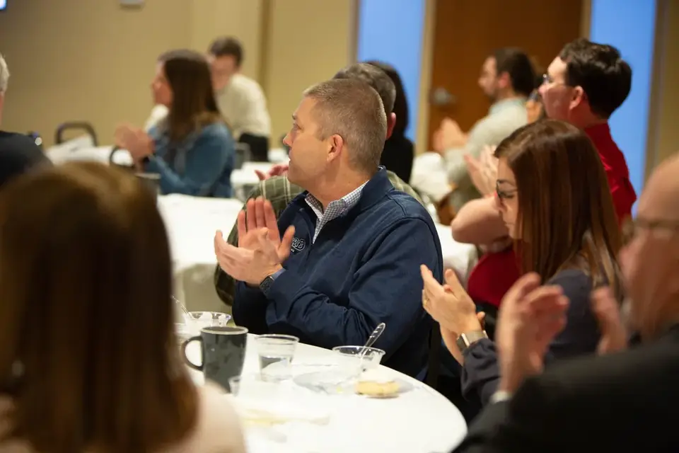 Chamber members applauding at a Chamber event