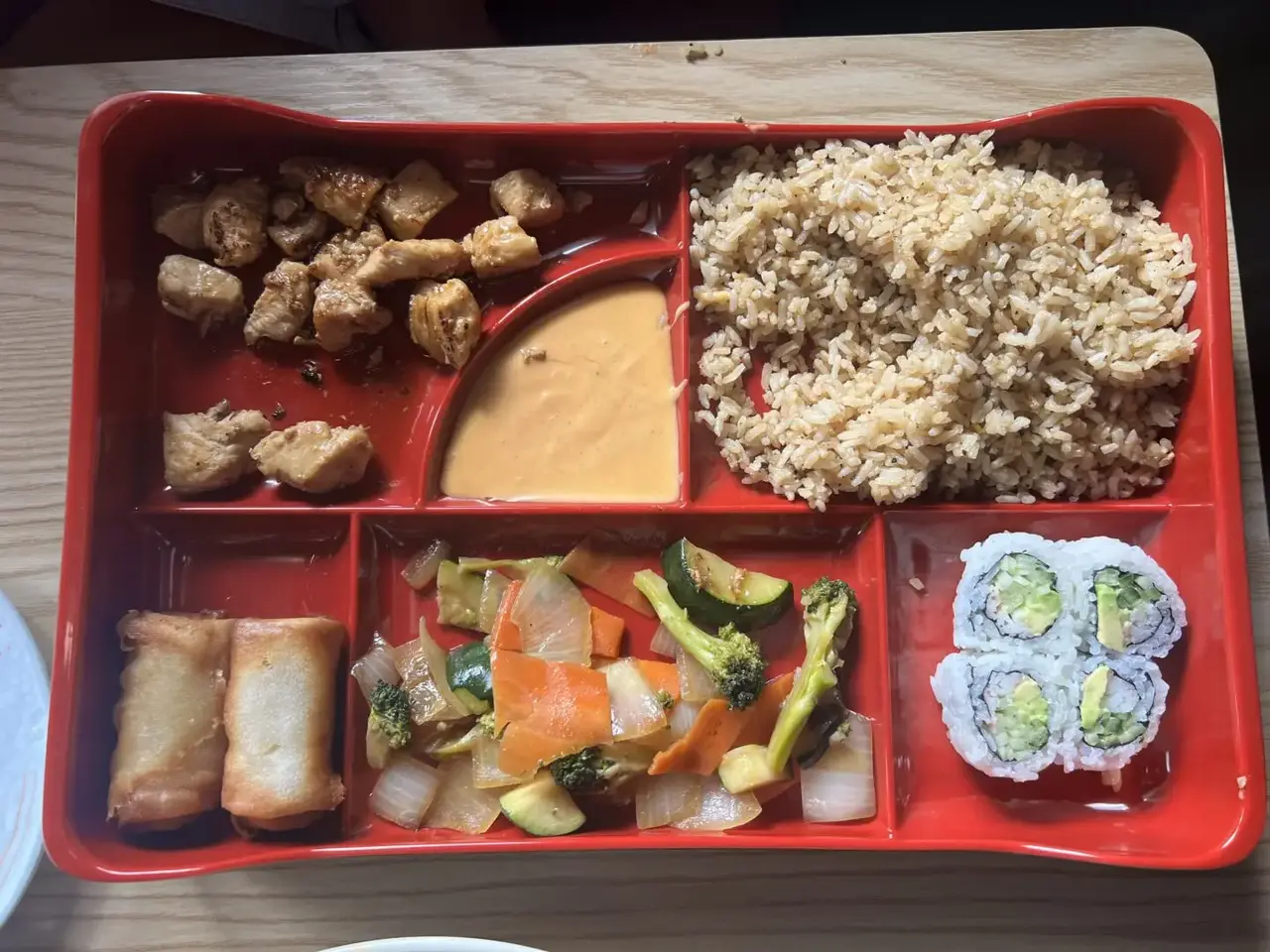 Chicken hibachi bento box with fried rice, sushi rolls, and spring rolls at Ichigo in Crestline, Ohio.