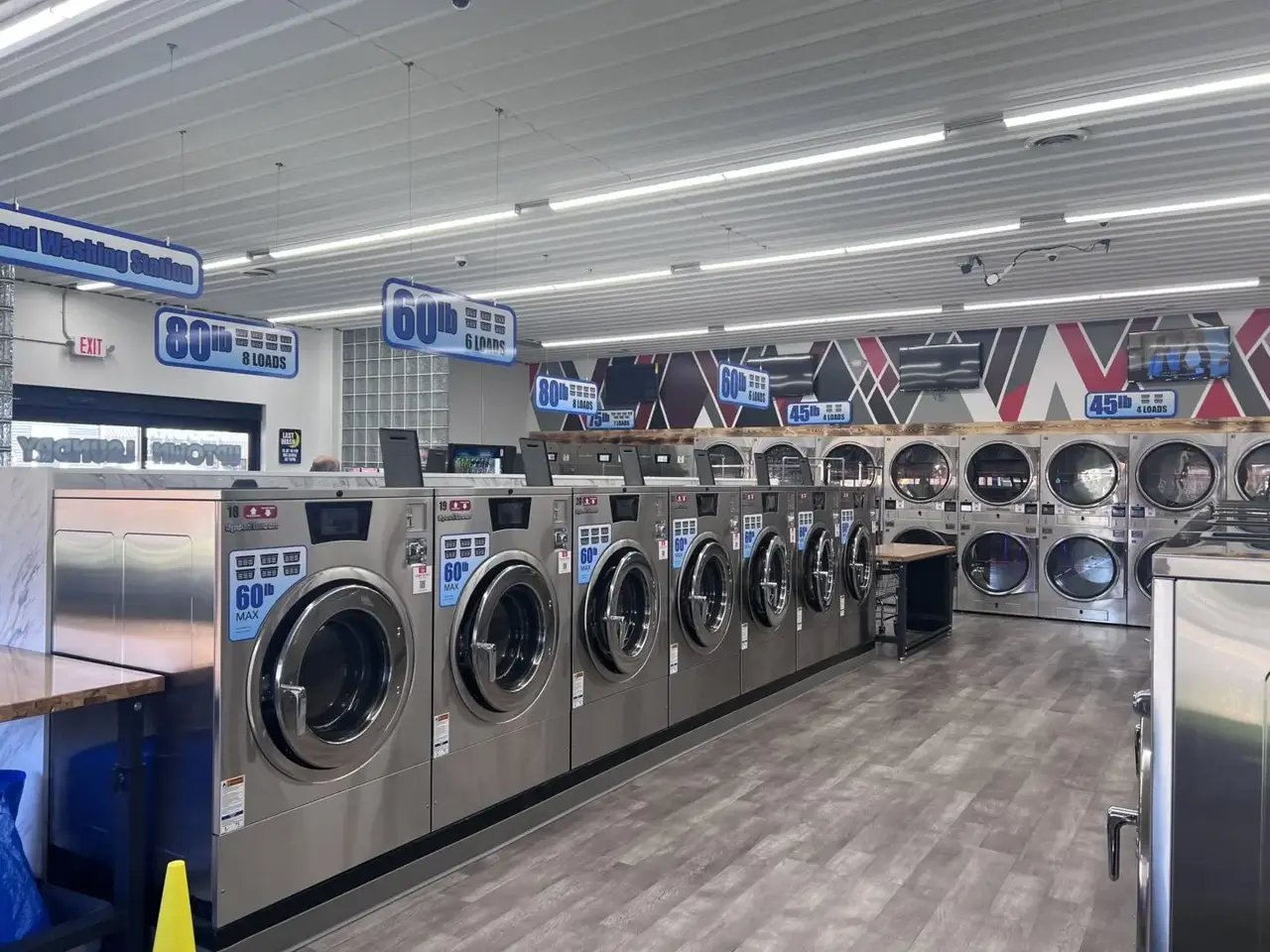 Wide interior view of Uptown Laundry showing multiple washer sizes designed to accommodate different laundry loads.